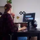 man sitting near table using computer