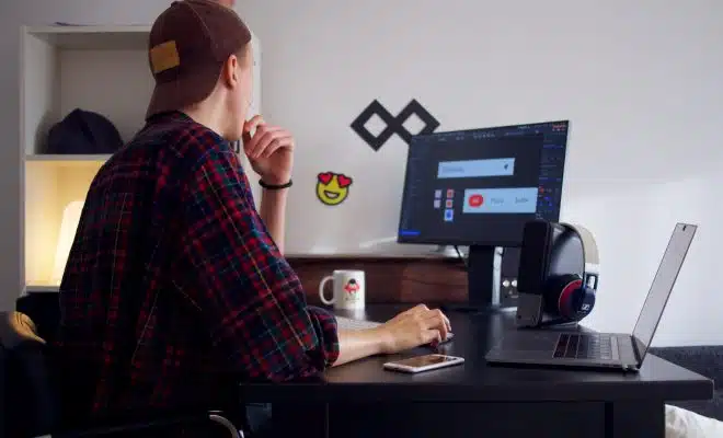 man sitting near table using computer